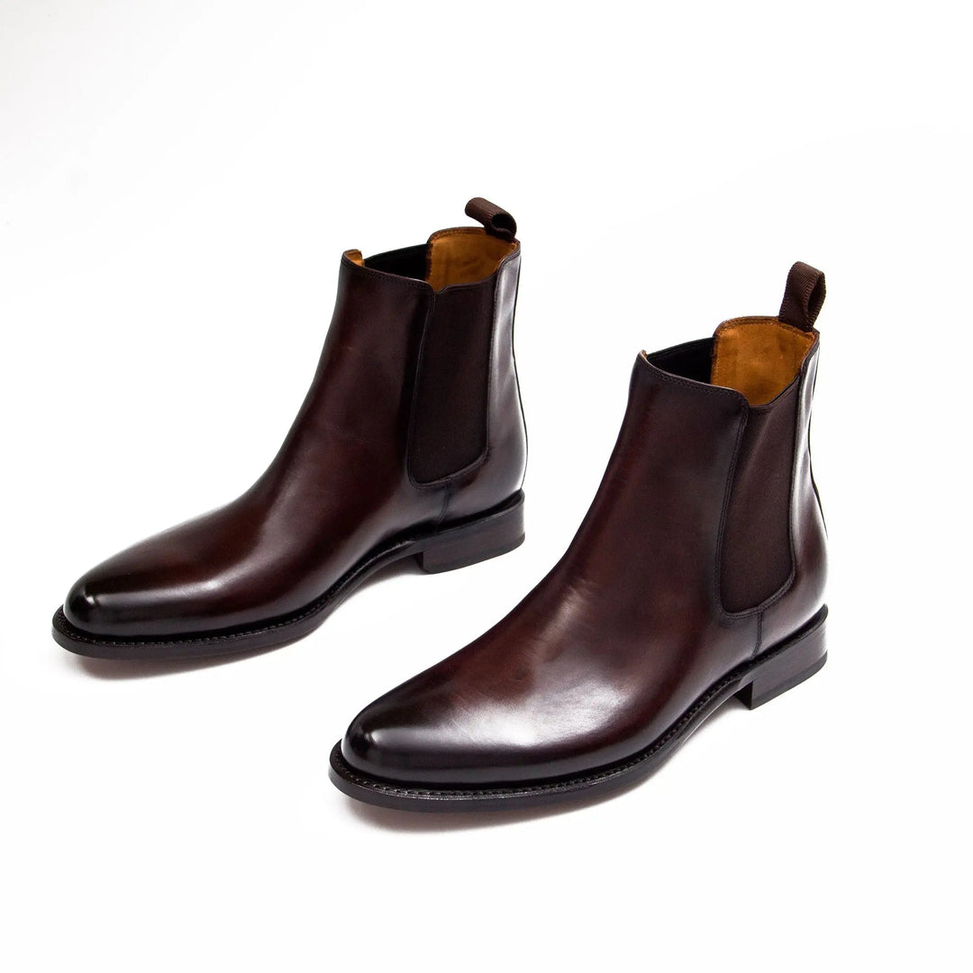 Pair of brown Chelsea boots showing rounded toe and elastic ankle panels