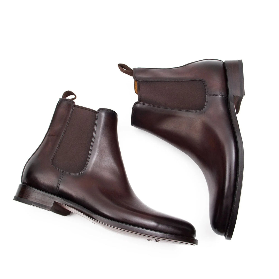 Brown Chelsea boots with elastic gore and low heel, angled view of heel and toe