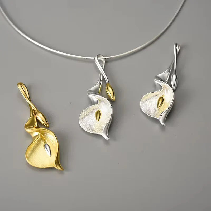 Calla lily necklace pendant in gold and silver with gold center, on a silver chain