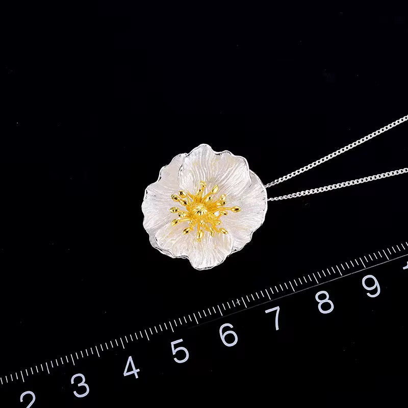 Wildflower blossom necklace pendant with gold center, silver chain shown with size ruler