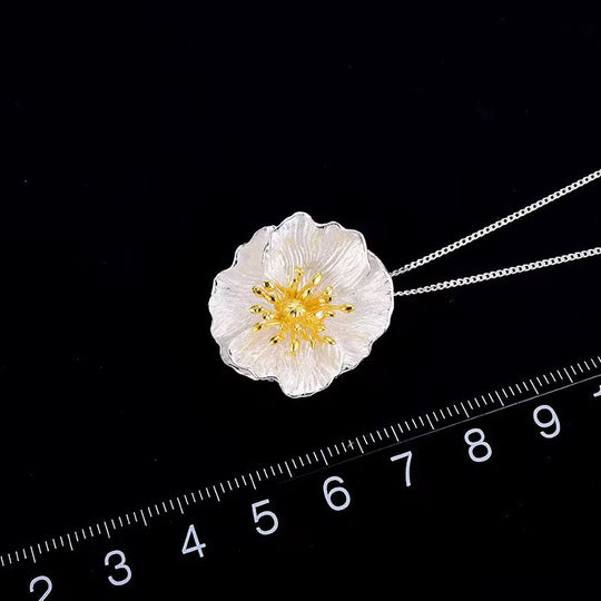 Wildflower blossom necklace pendant with gold center, silver chain shown with size ruler