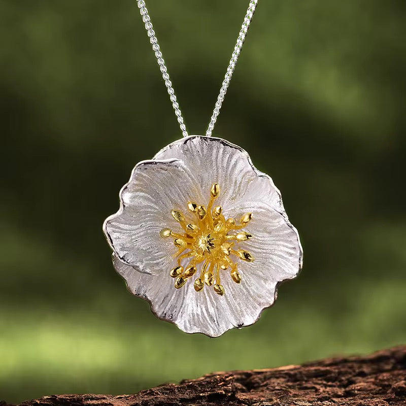 Silver wildflower blossom pendant with gold stamen on thin chain