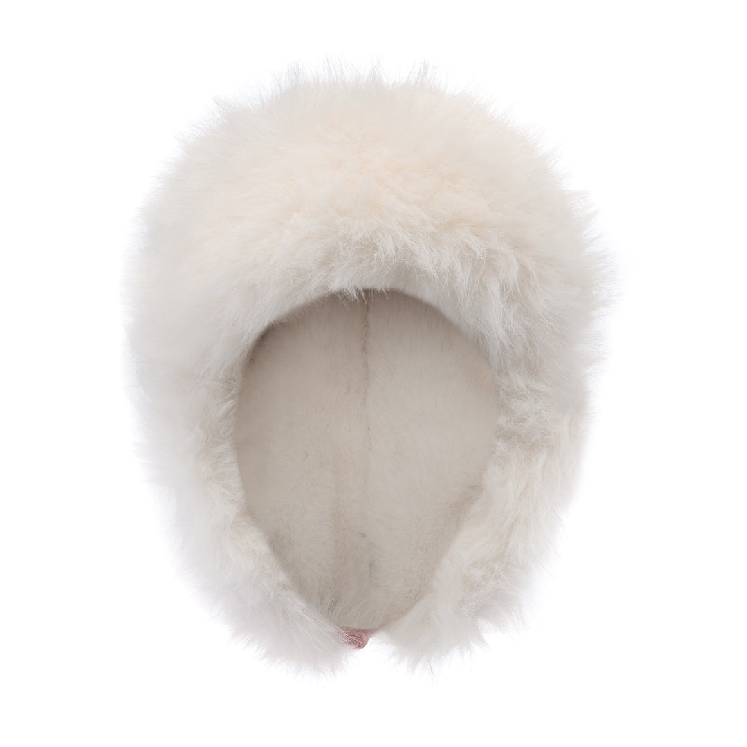 White faux-fur trapper hat from front, plush ear flaps framing the face opening