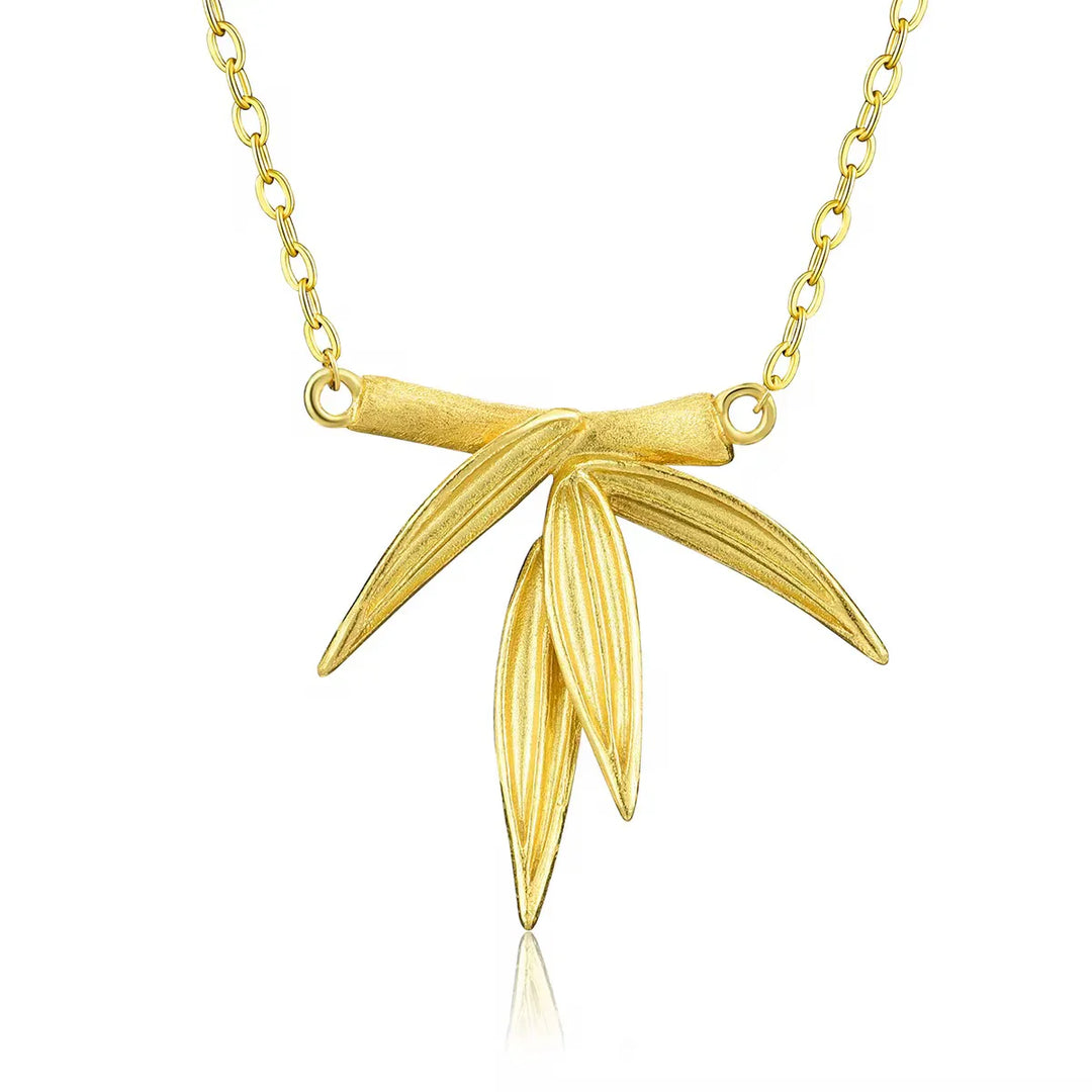 Bamboo necklace with gold chain and ribbon-style leaf pendant, polished finish.
