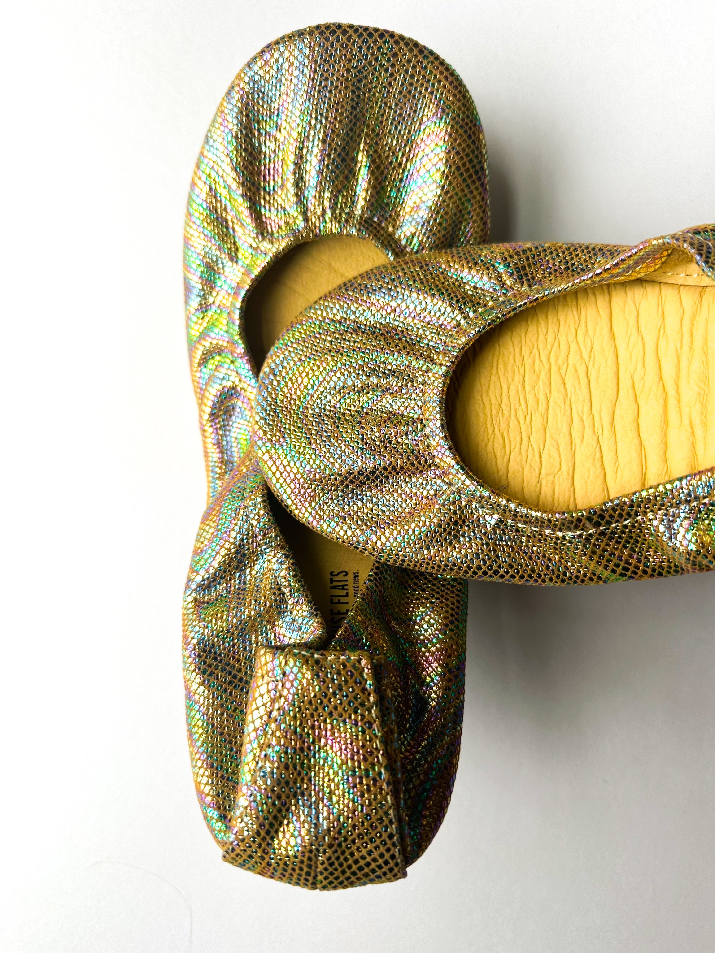 Metallic iridescent slip-on flats with bow detail, cushioned insole lining