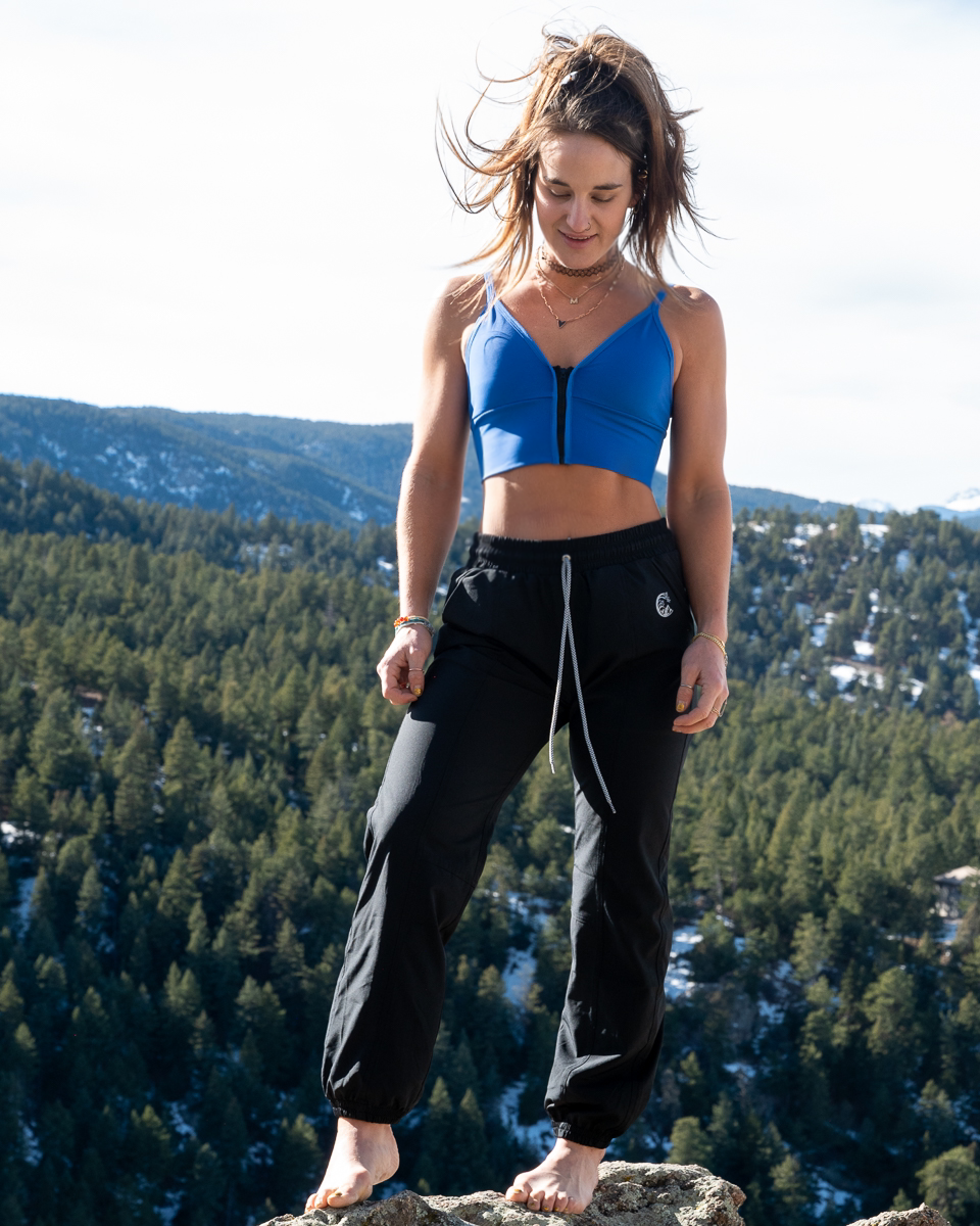 Black performance joggers with drawstring waist and gathered ankle cuffs.