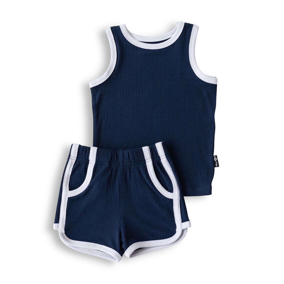 Navy track shorts set flat lay: sleeveless tank top and shorts with white piping