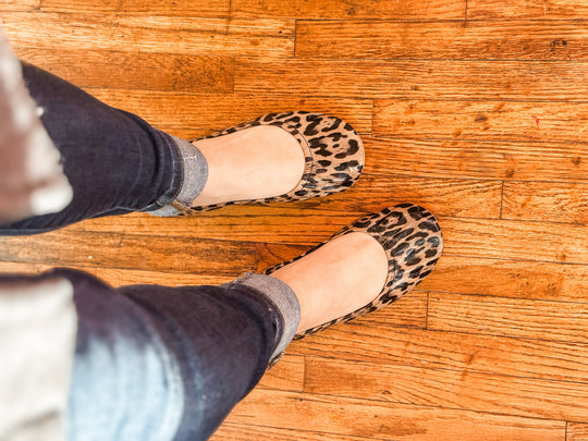 Leopard Lyla flats on wooden floor, round toe and low profile