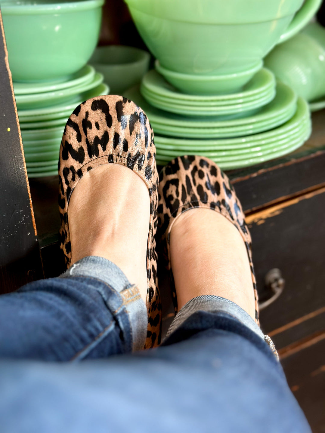 Leopard print flats on feet with elastic ankle opening