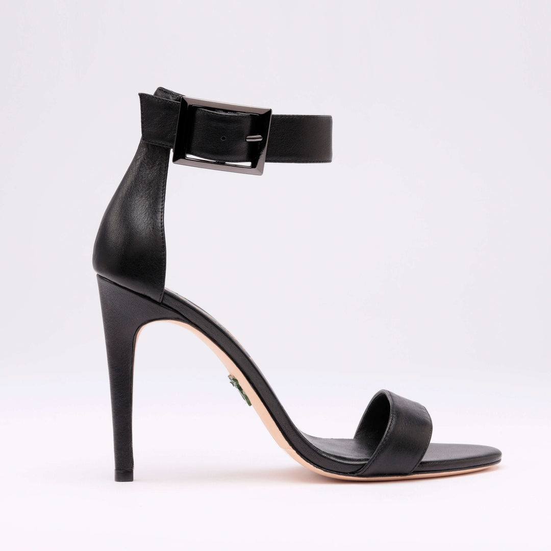 Black heeled sandal side profile with ankle strap and block-heel