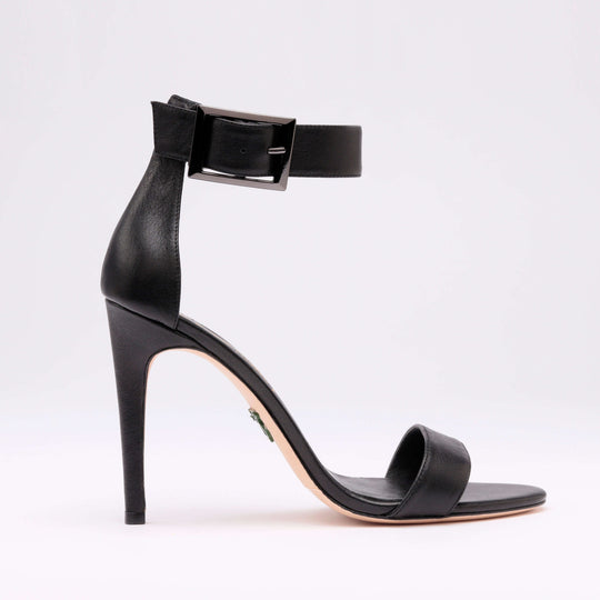 Black heeled sandal side profile with ankle strap and block-heel