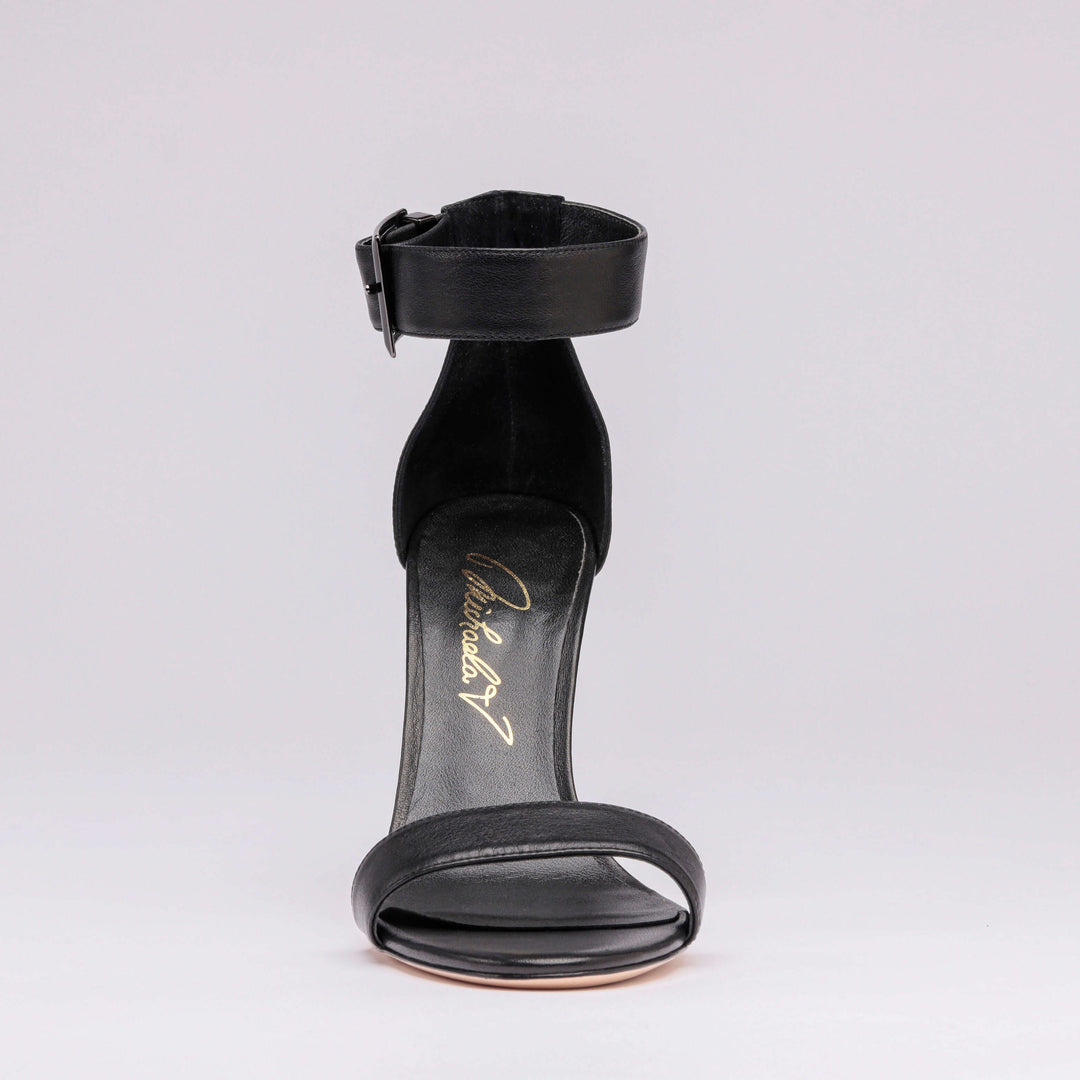Black heeled sandal back view with ankle strap and open heel