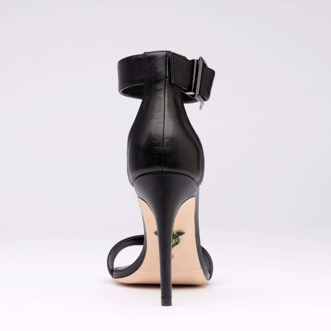 Black heeled sandal heel view with ankle strap buckle detail