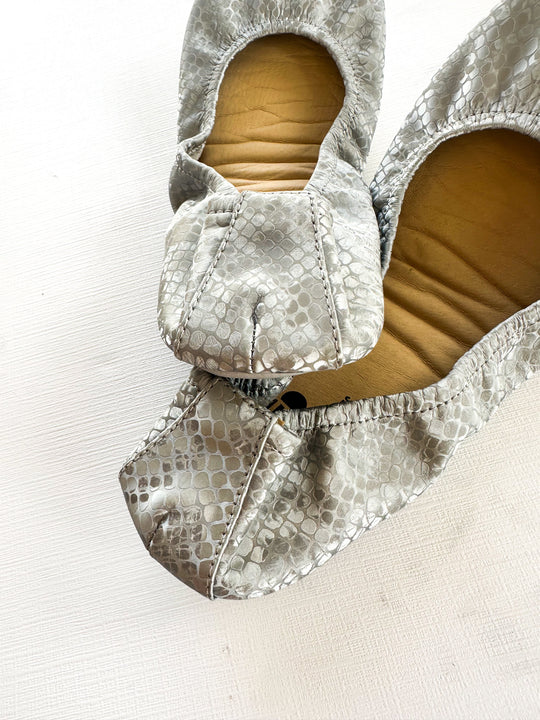 Dusty Snakes slip-on flats with snakeskin texture and ankle bow detail