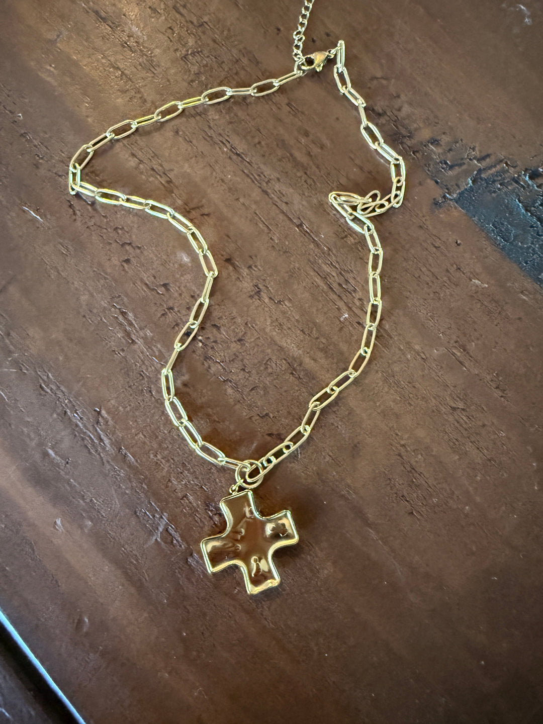 Chunky hammered cross pendant on gold-tone link necklace, waterproof style