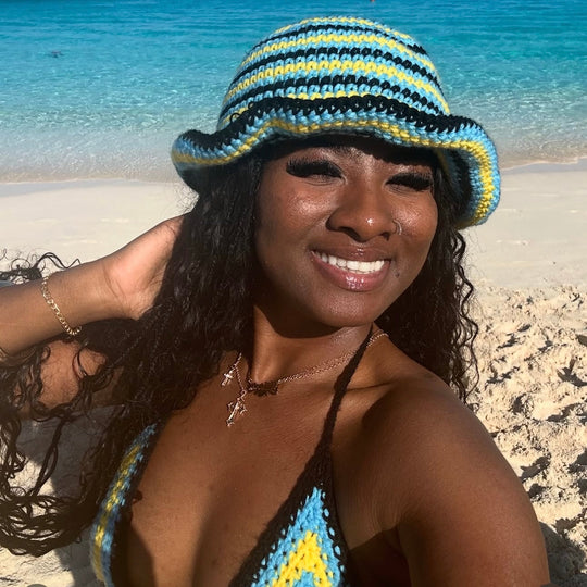 Striped crochet bucket hat with dark blue brim and yellow/light blue crochet rows