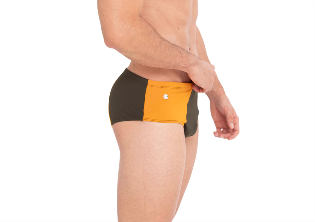 Orange front band and dark back panel; round logo button at waistband