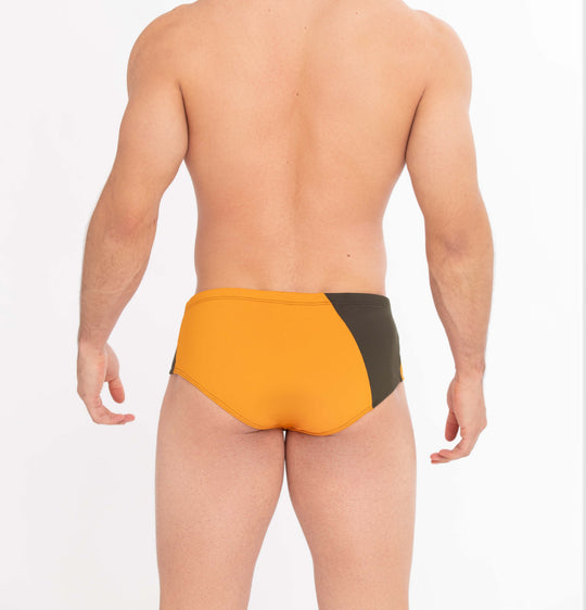 Back view of two-tone athletic swim briefs in orange and dark with contrast side panel