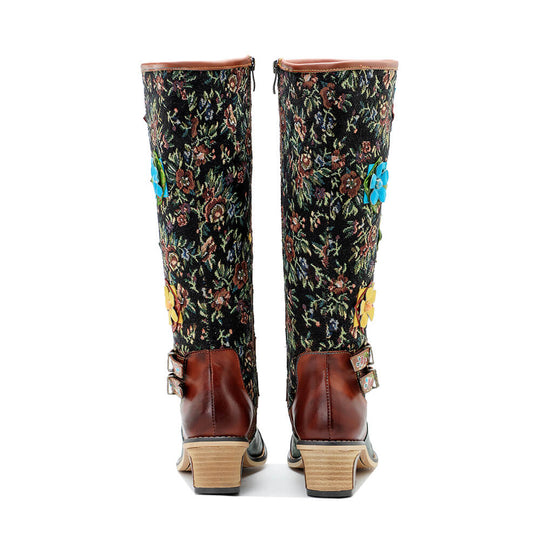 Back view of tall boots with floral shaft, maroon heel and decorative blue flower accents