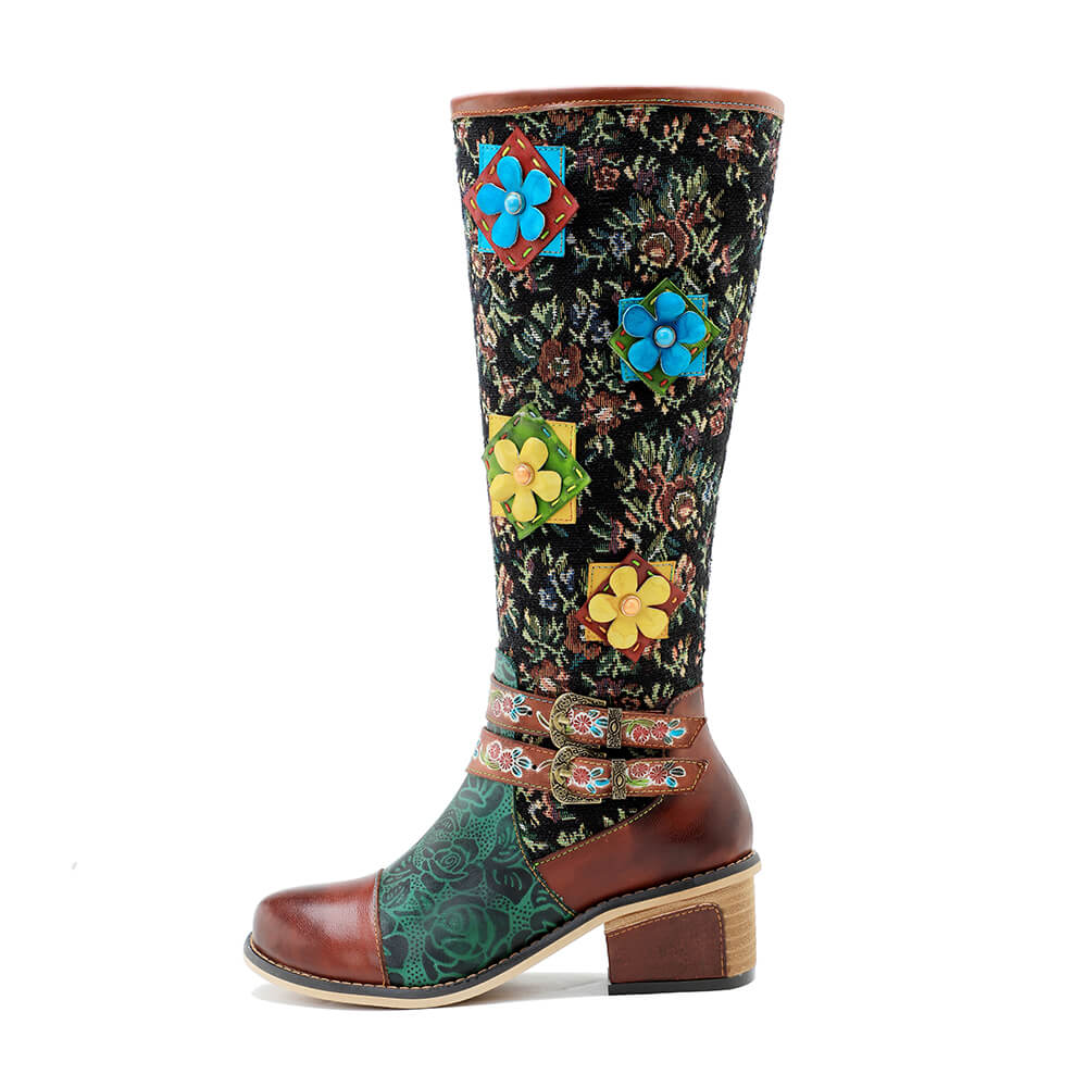 Front 3/4 view tall boots with colorful 3D flowers, patterned shaft, sturdy block heel