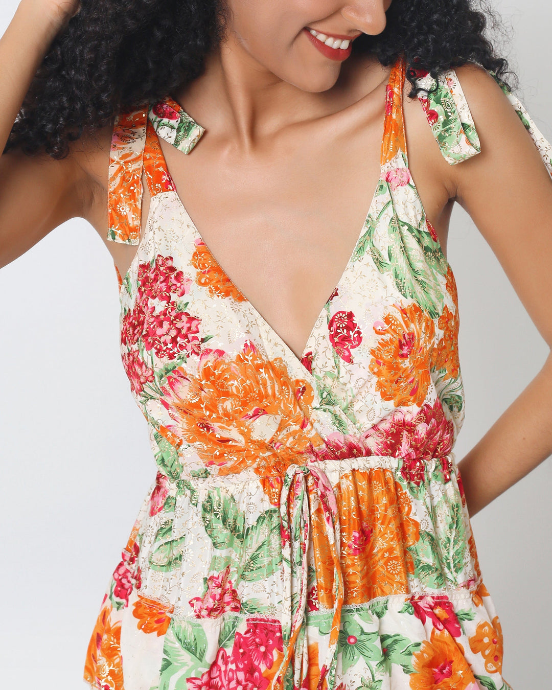 Ithaca Dress close-up: floral V-neck with adjustable shoulder ties and gathered waist