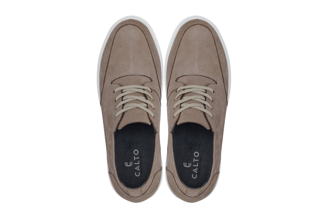 Khaki boots with lace-up top, dark insole lining, and white rubber sole
