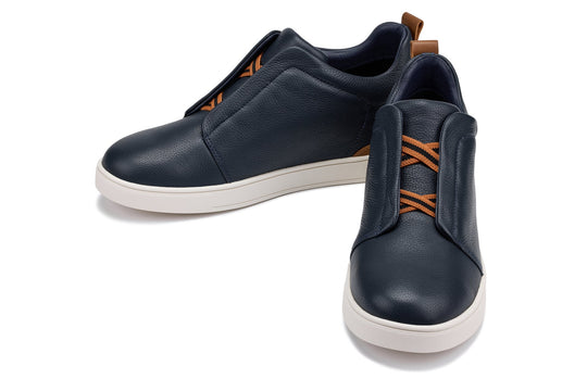 Navy slip-on sneakers with orange stripe accent and cushioned collar