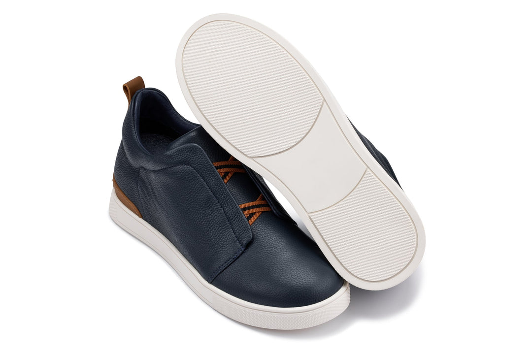 Navy slip-on sneaker pair with white outsole and sidewall stitching