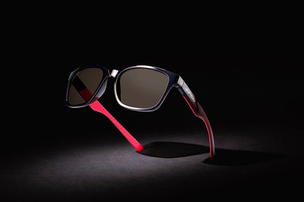 Black golf sunglasses with dark lenses and pink textured temples