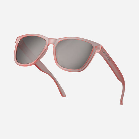 Fringe Golf sunglasses with rose frame and dark lenses, angled front view