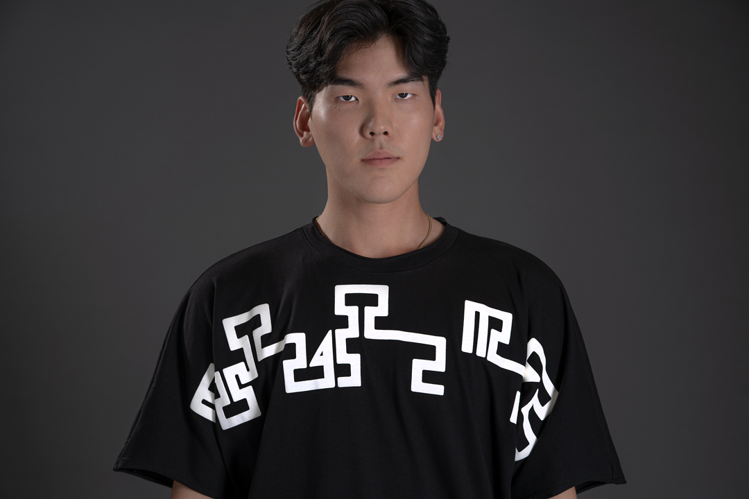 Black crewneck tee with centered white geometric print and white sleeve graphic.