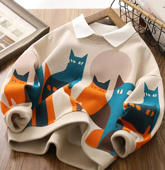 Close view of beige boys hoodie with colorful cat print panel