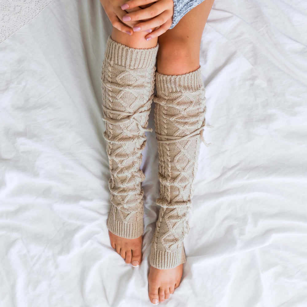 Long cable-knit leg warmers in ivory with diamond and cable knit texture