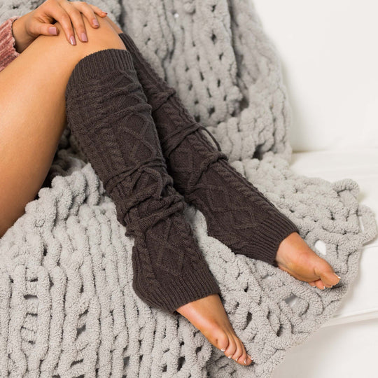 Long cable-knit leg warmers in dark gray with braided cable knit pattern