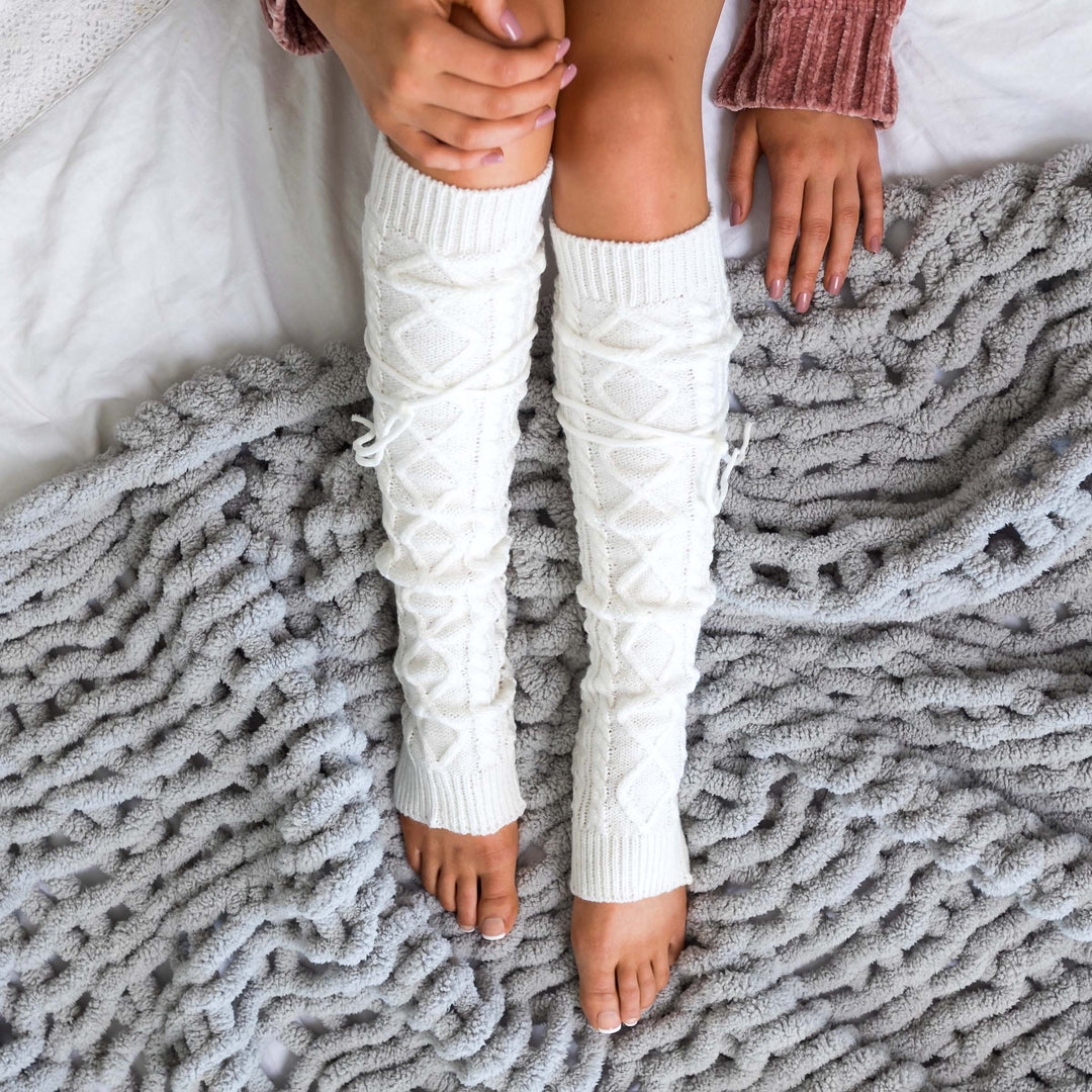 Long cable-knit leg warmers in white/ivory with raised cable and lattice knit