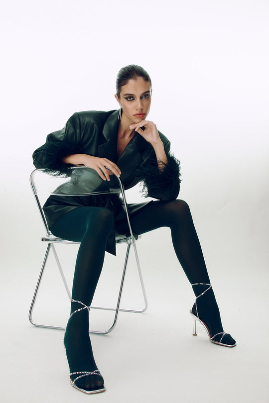 Model wearing silver rhinestone 90 heeled sandals with thin straps and open toe