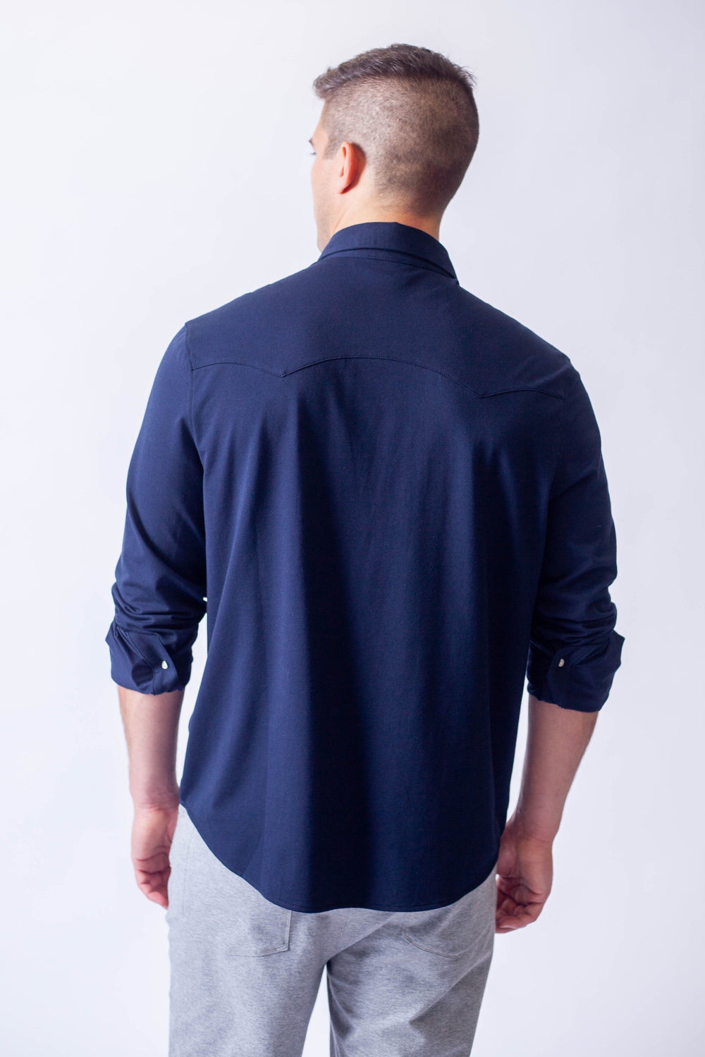 Back view of navy Western tech shirt with yoke seam detail
