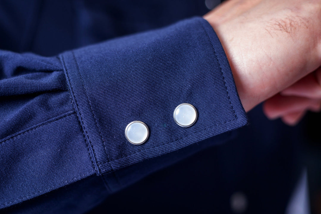 Navy Western tech shirt cuff with two snap-style buttons on sleeve end