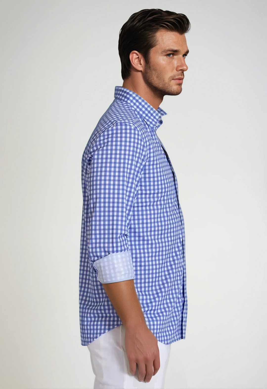 Blue gingham button-up dress shirt on model, side profile, long sleeves