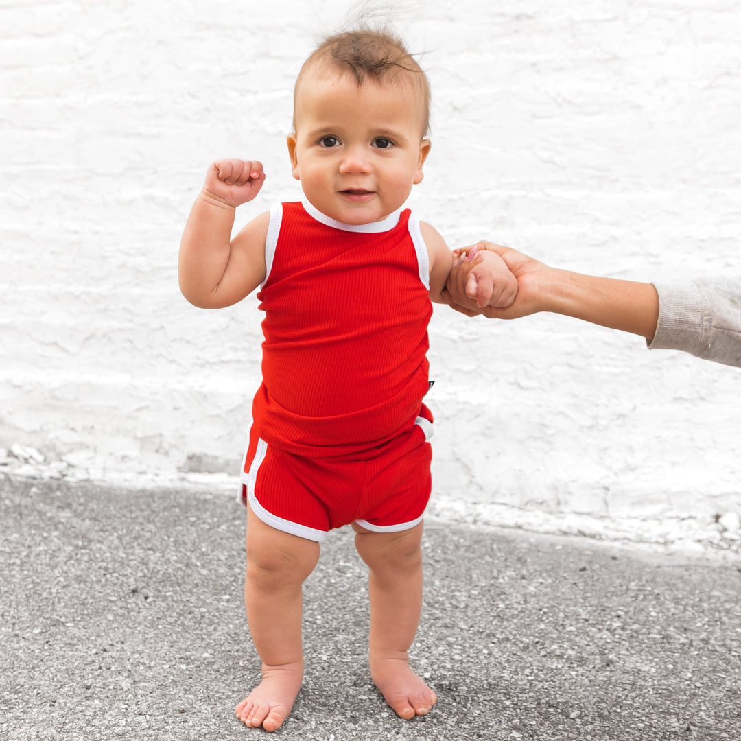 Red track shorts set with white trim—sleeveless tank and matching pull-on shorts