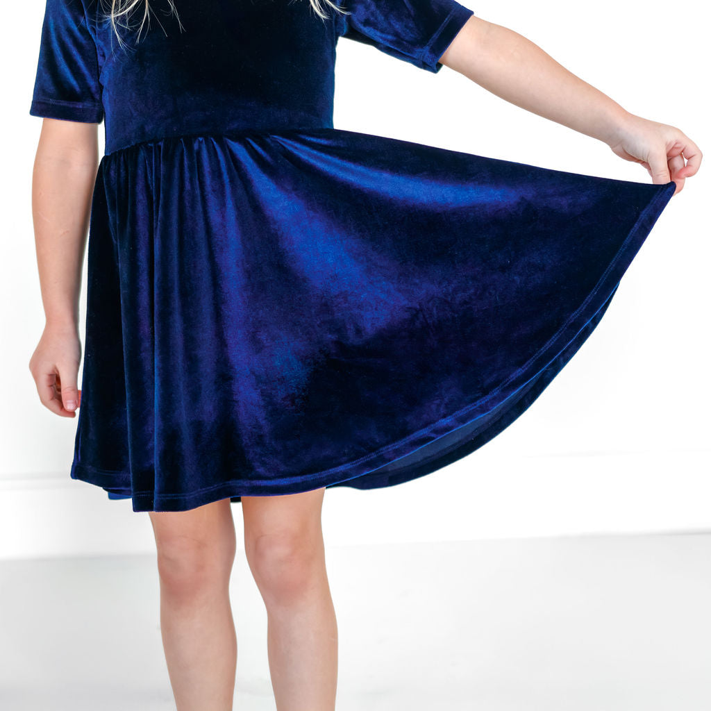Dark navy stretch velvet twirl dress with mid-length sleeves and gathered skirt