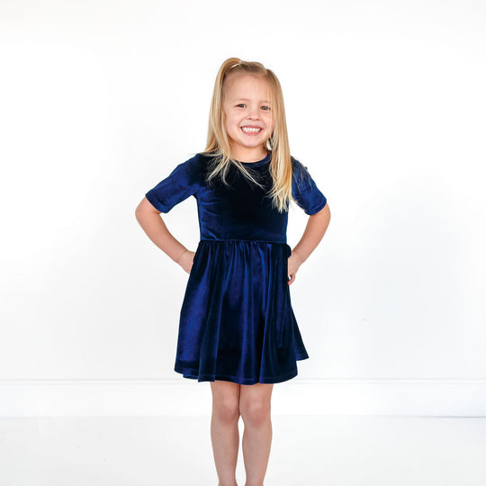 Navy velvet twirl dress with short sleeves, elastic waist, and flared skirt