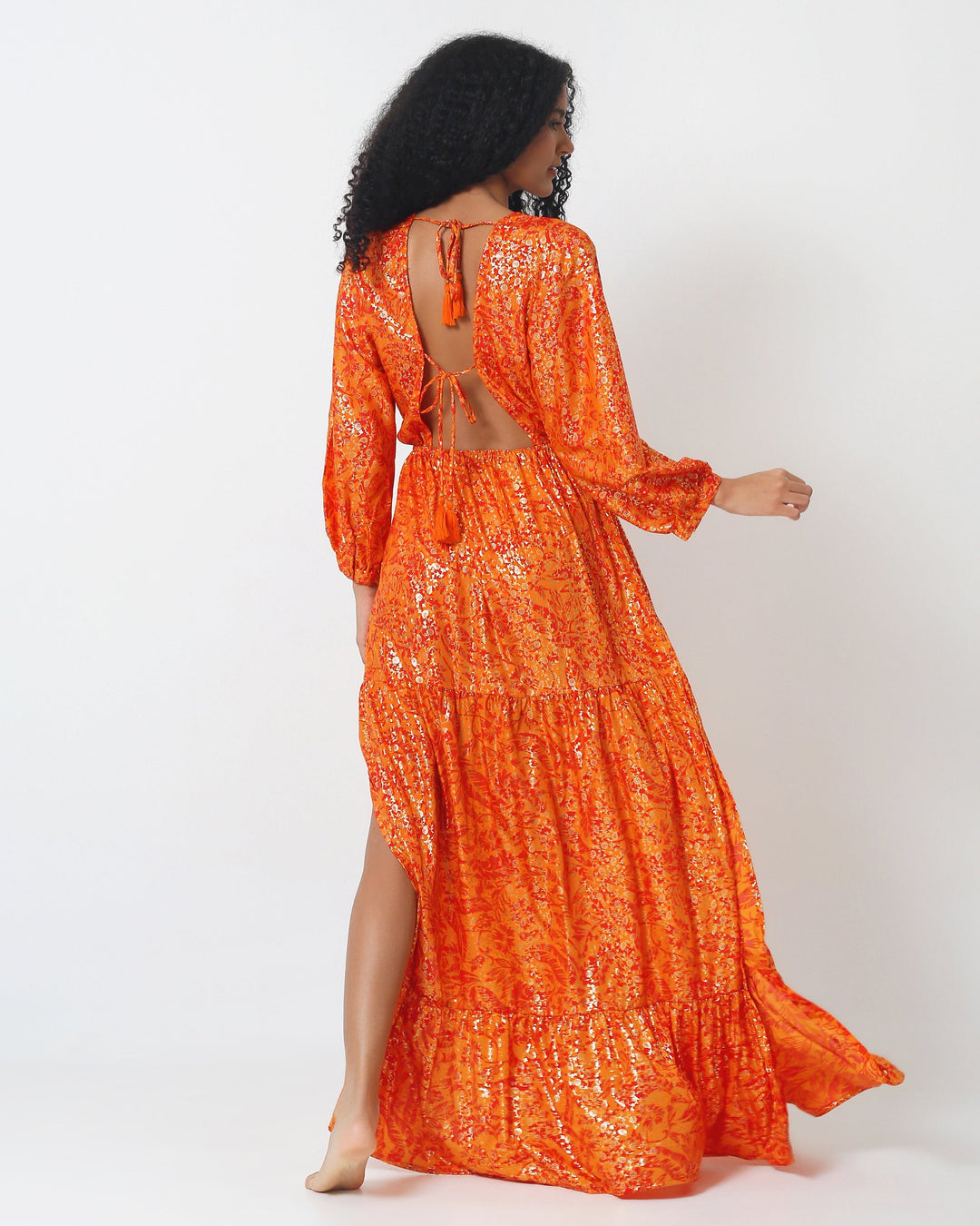 Morocco Dress back view: orange printed tiered maxi skirt with long sleeves