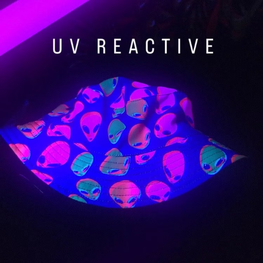 UV reactive bucket hat glowing neon alien pattern under blacklight