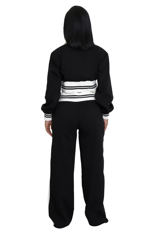 Back view: black pants set with white stripe waistband and hooded jacket