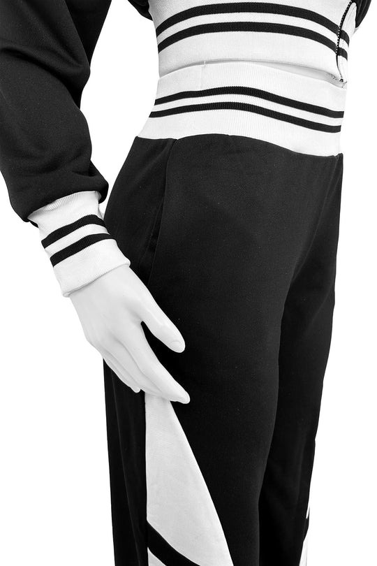 Close-up of black pants: white stripe panel and ribbed striped waistband