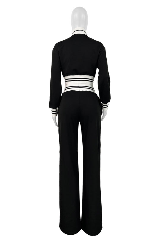 Back view: black flared pants and zip jacket with striped waistband