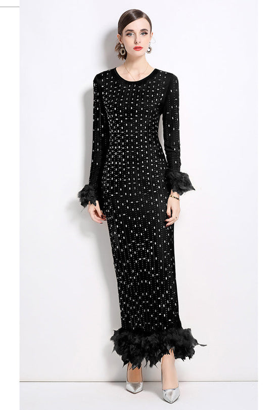 Black fitted maxi dress with sparkling sequin pattern and feather-trim hem
