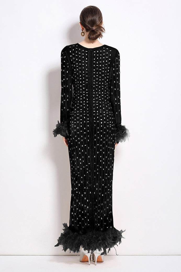 Back view of black sequin maxi dress with long sleeves and feather-trim hem