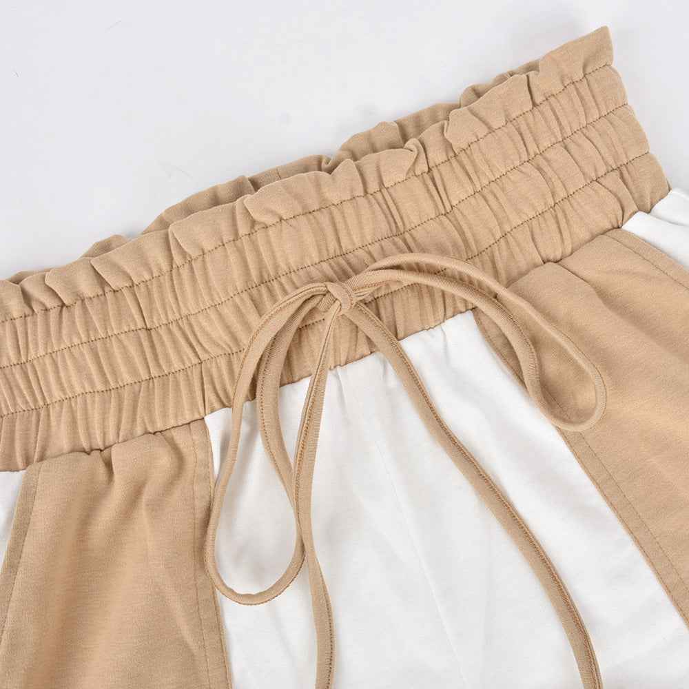 Elastic waistband and tan drawstring on beige-and-white shorts